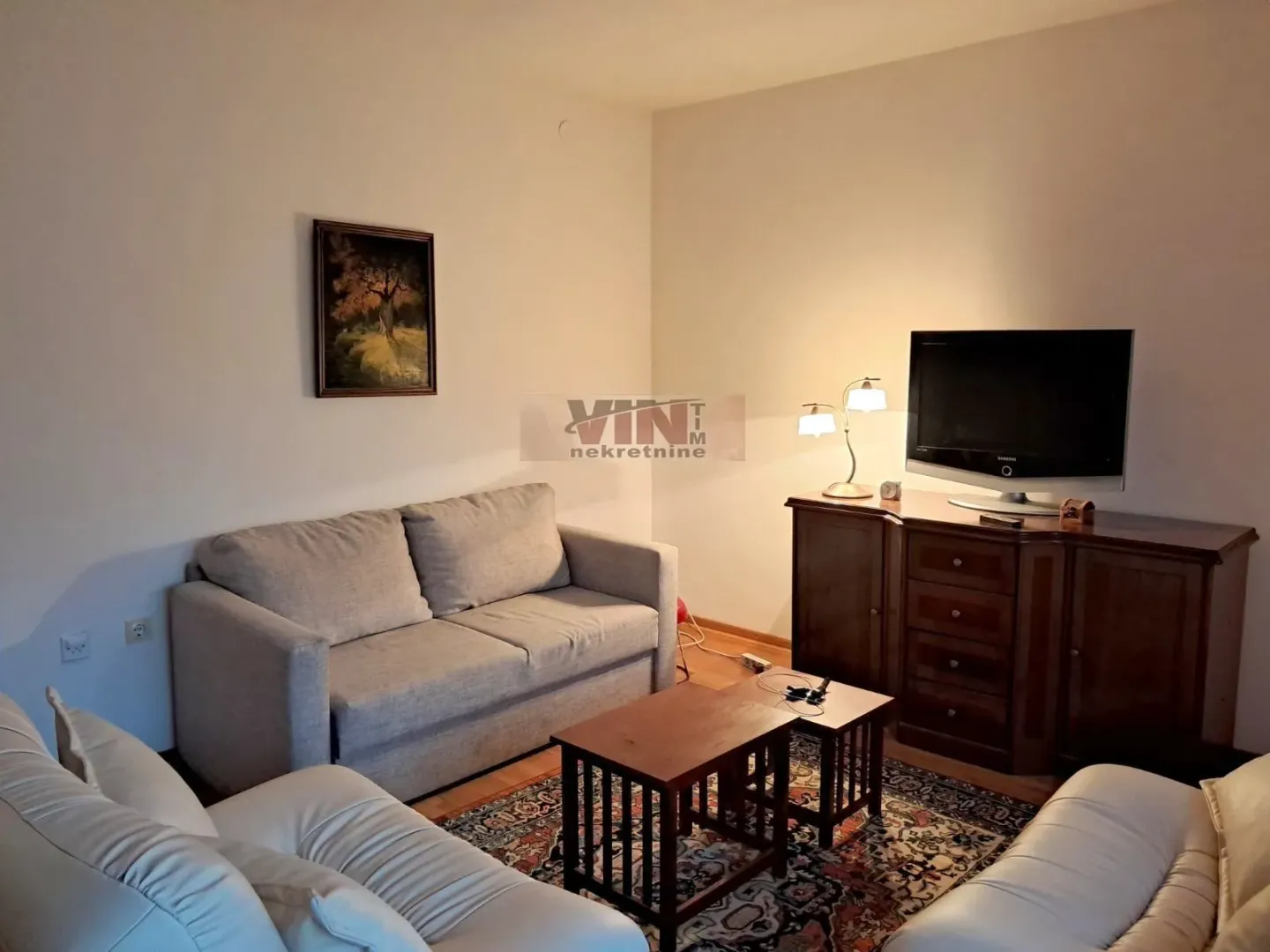 Furnished living room with sofa set, TV cabinet and coffee table.