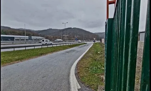 View of the access road and surroundings with the highway in the background. - image 8