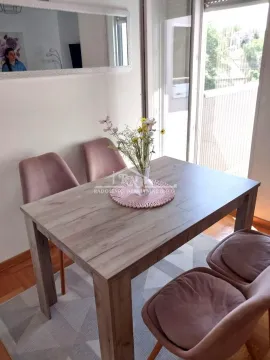 Dining table with chairs in a bright living room with access to the terrace. - image 16