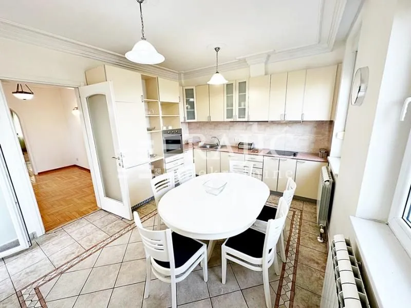 Spacious kitchen with a dining area and light-colored cabinetry.