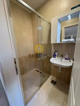 Small bathroom with a shower cabin and a sink. - image 3