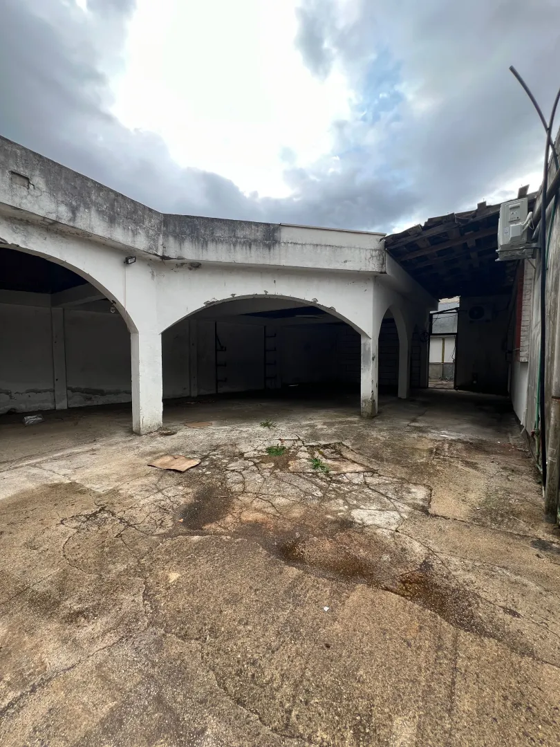 Exterior part of the building with a covered porch and a concrete courtyard.
