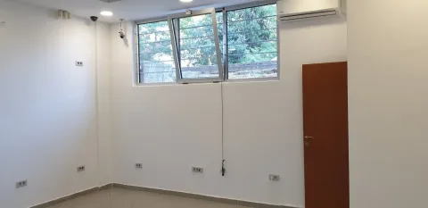 An empty room featuring a window, an air conditioning unit, and security cameras. - image 5