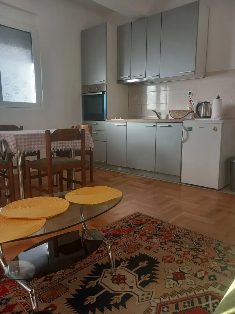 Kitchen with a dining area and grey cabinets.