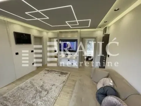 Modern living room with a sofa and decorative ceiling lighting. - image 6