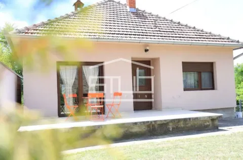 Front view of the house with a covered terrace and a table with chairs. - image 20