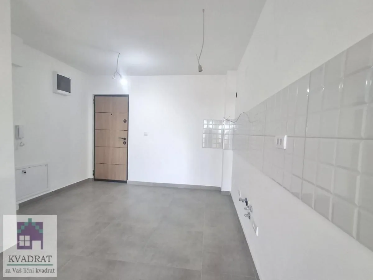 Empty kitchen with prepared installations and ceramic wall tiles.