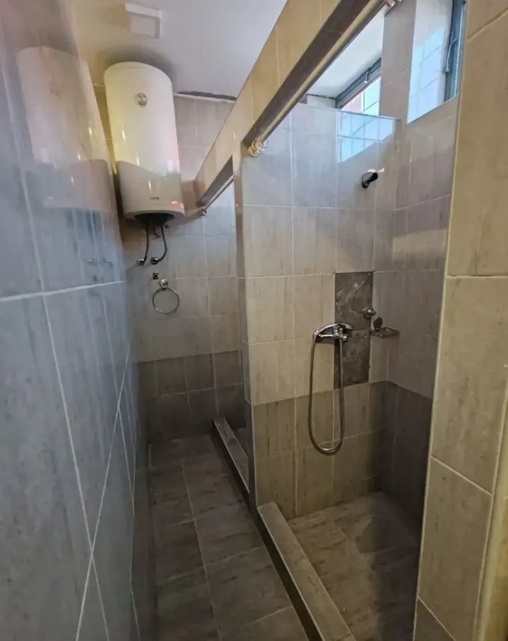 View of a modernly equipped bathroom with a walk-in shower.
