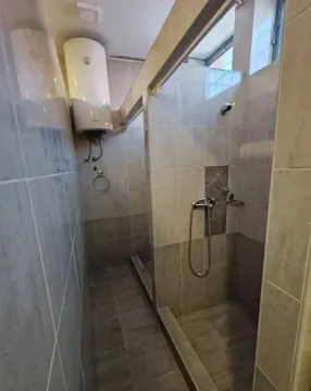 View of a modernly equipped bathroom with a walk-in shower. - image 20
