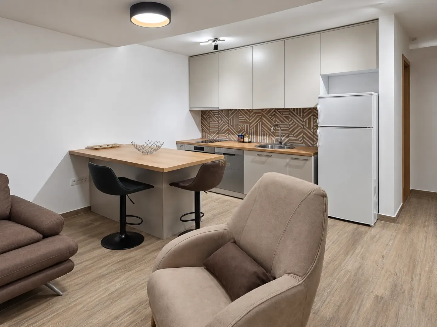 Modern kitchen with a breakfast bar and dining area connected to the living room.