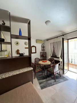 Living room with a dining table and access to the terrace. - image 4