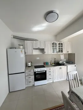Bright kitchen with white cabinets and appliances. - image 4