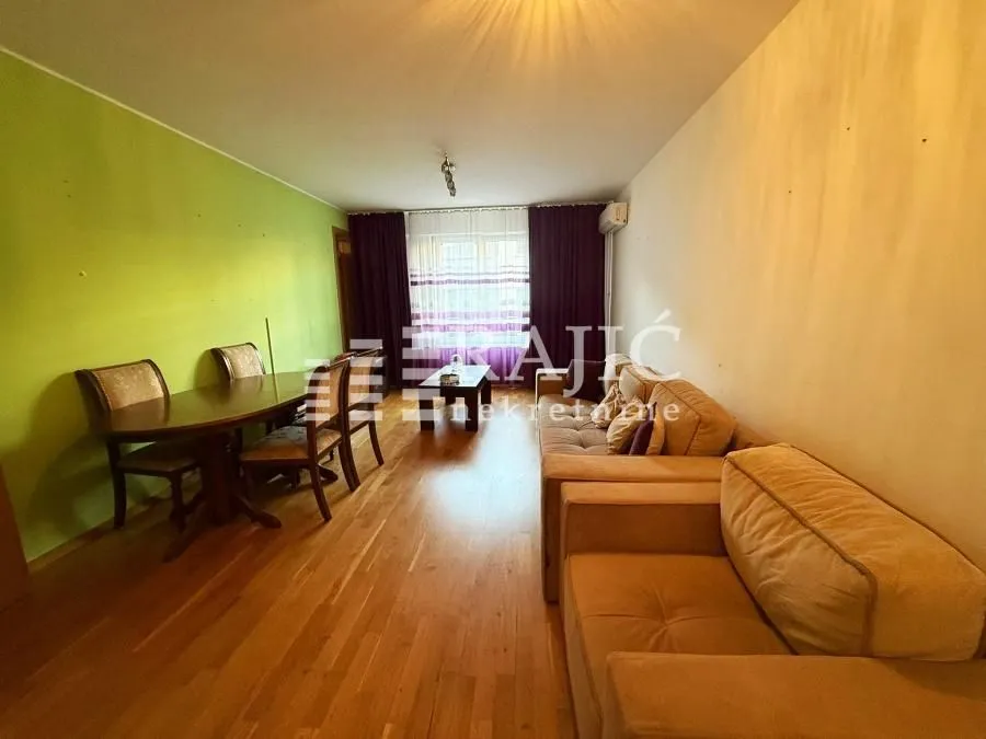 Spacious living room with a sofa set and dining table.