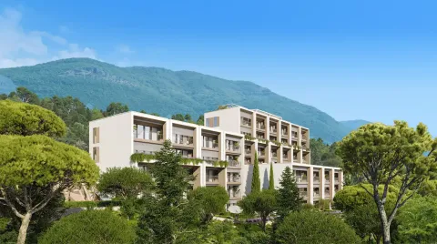 Pogled na spoljašnjost moderne stambene zgrade okružene zelenilom i planinskim pejzažom. - image 3