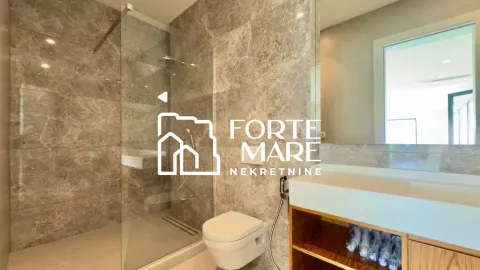 Modern bathroom with a walk-in shower tiled with marble tiles. - image 2