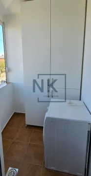 Enclosed balcony with a white wardrobe and a washing machine. - image 12