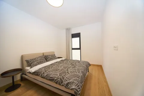 Bedroom with a double bed and wooden flooring. - image 5