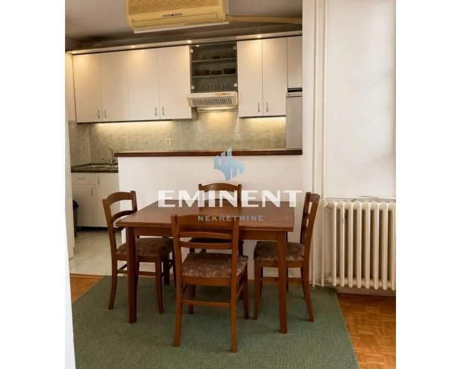 Kitchen with dining area and wooden table and chairs.