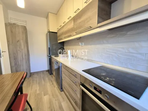 A view of a modern equipped kitchen with built-in units and appliances. - image 4