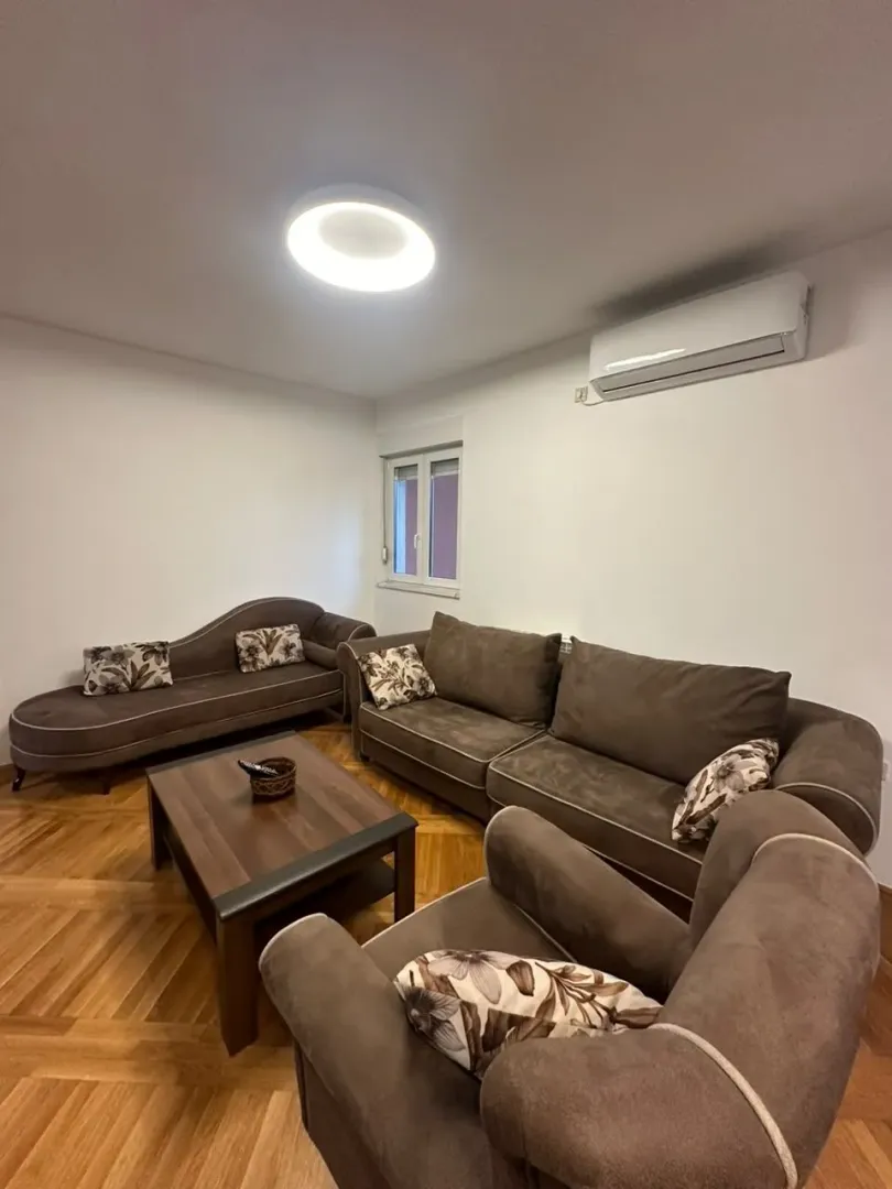 Living room with a sofa set, armchair, and a wooden coffee table.