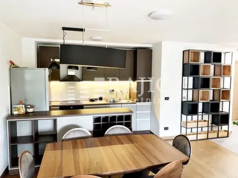 Modern kitchen with dining area and open layout. - image 3