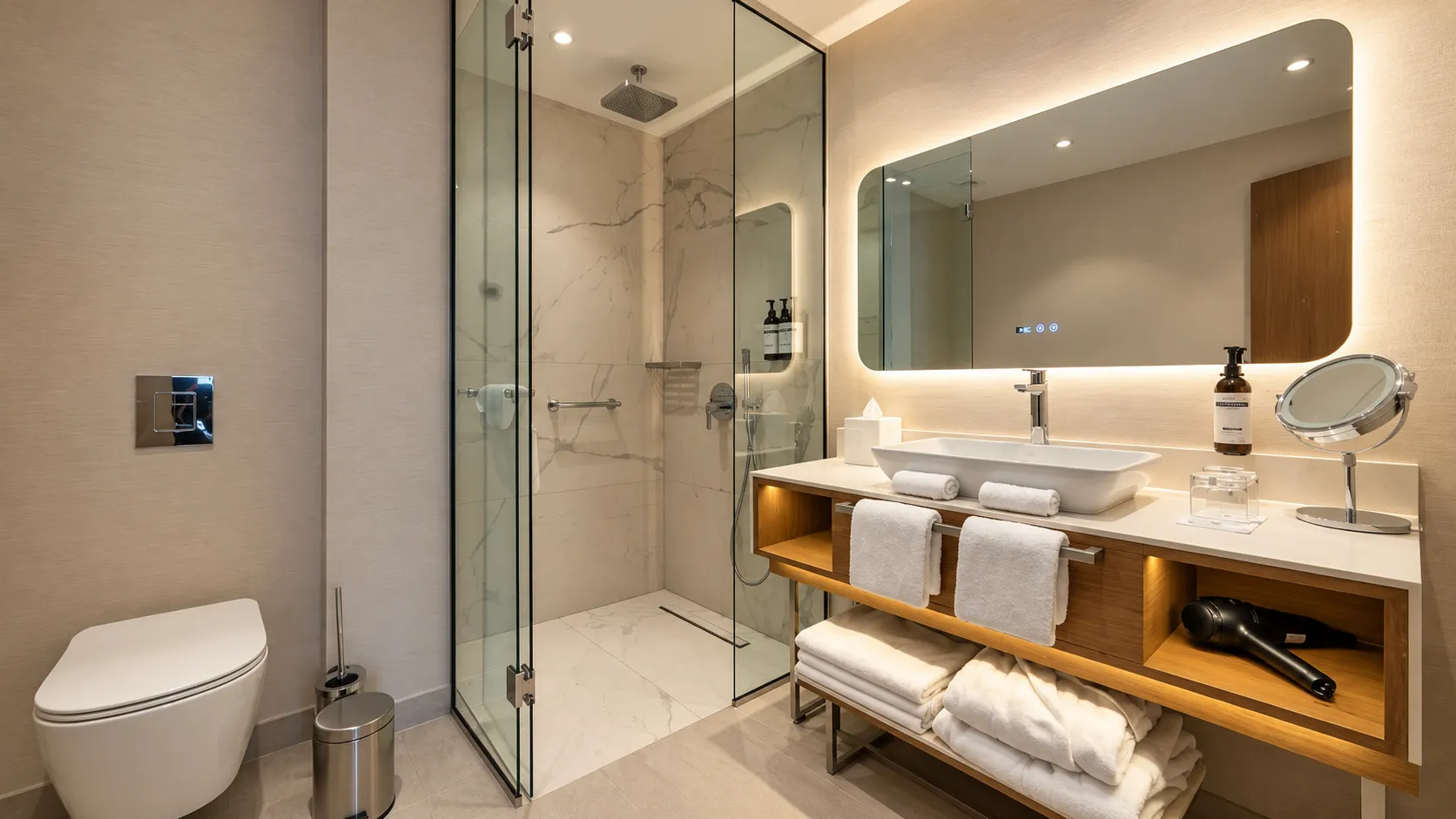 Modern bathroom with a walk-in shower, washbasin, and illuminated mirror.
