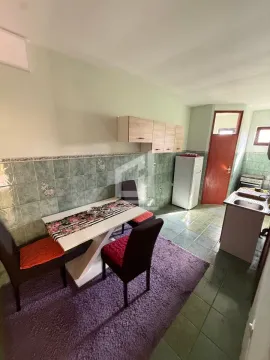 Kitchen with a dining area and a door exit. - image 5