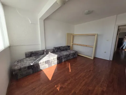 Living room with dark wooden flooring and a sofa. - image 22