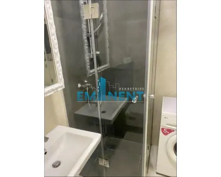 Small bathroom with a shower cabin and a sink. - image 10