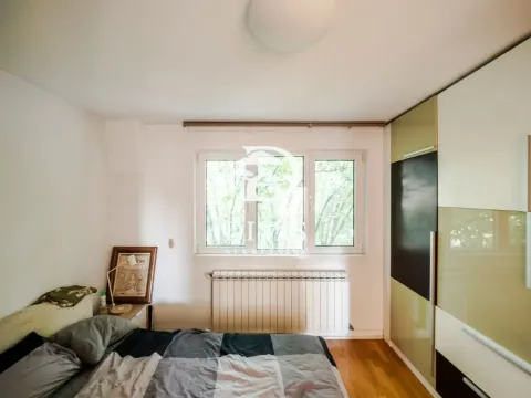 A view of a furnished bedroom with a window and a built-in wardrobe. - image 5