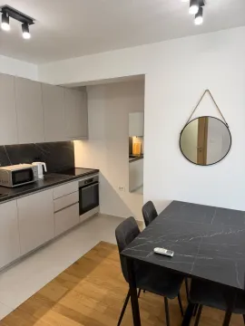 Kitchen with a dining area and modern interior elements. - image 5