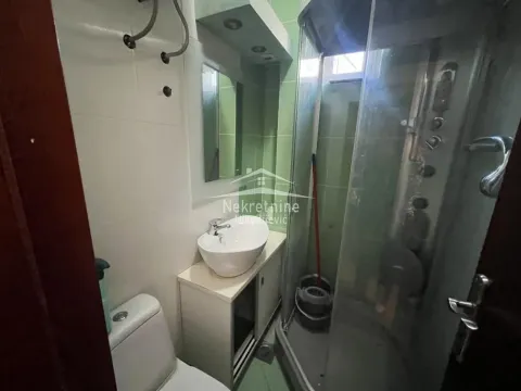 Smaller bathroom with a washbasin, toilet, and shower cabin. - image 15