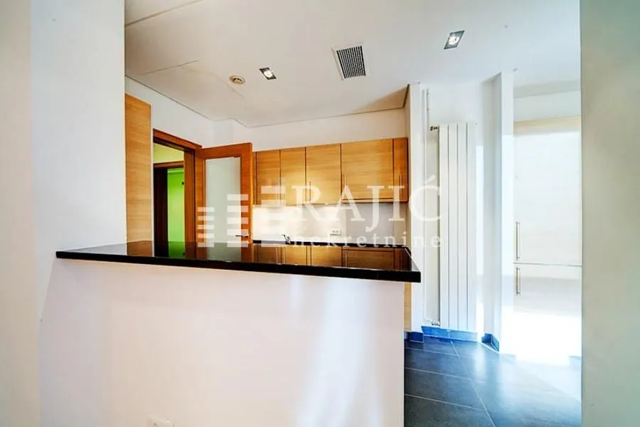 Modern kitchen with a breakfast bar and wooden cabinetry.