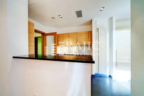 Modern kitchen with a breakfast bar and wooden cabinetry. - image 6