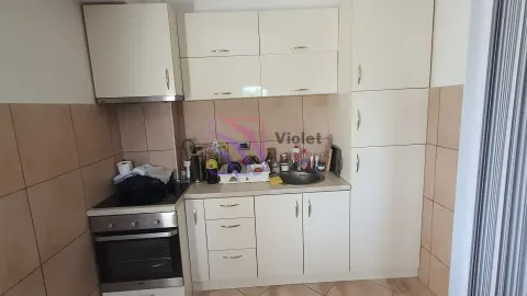 Small kitchen with white cabinets and built-in appliances. - image 9