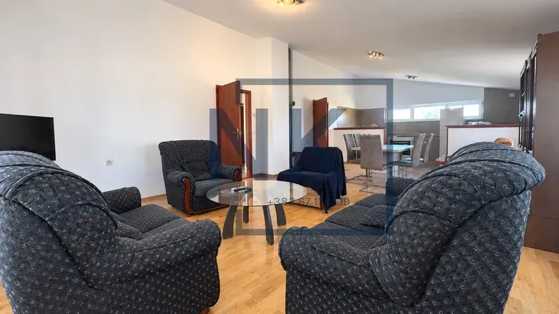 Spacious living room with a seating set and a view of the dining area.