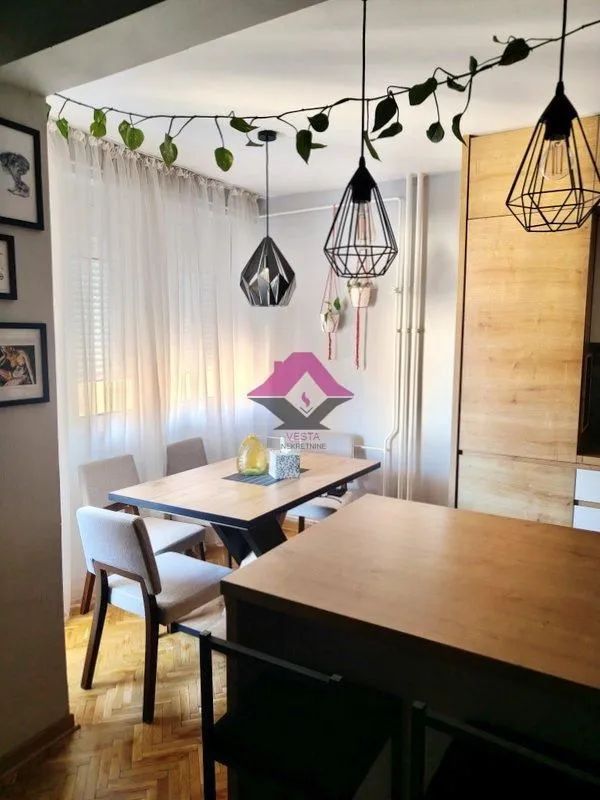 Dining area with a dining table and chairs, connected to the kitchen.