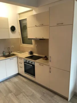 Modern kitchen with light cabinets and built-in oven. - image 8