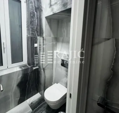 Modernly equipped bathroom with marble tiles. - image 14