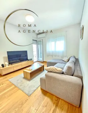 Living room with sofa, TV unit, and access to the terrace. - image 3