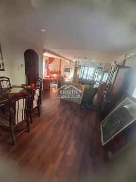Spacious living room with a dining area and wooden flooring. - image 2