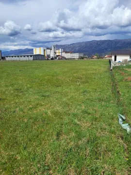 Prostrani zeleni plac sa pogledom na planine u pozadini. - image 7