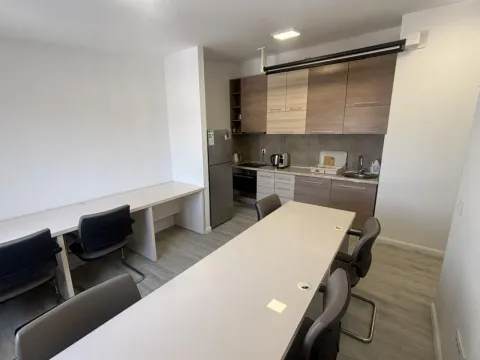 Kitchen with a dining table and chairs. - image 12