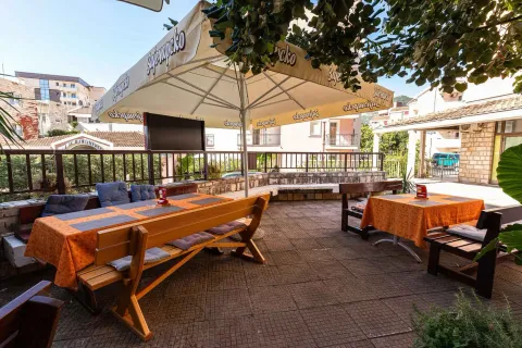 Spacious outdoor terrace with tables and umbrellas. - image 6