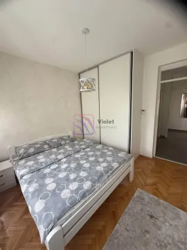 Bedroom with a double bed, white wardrobe, and hardwood flooring. - image 13