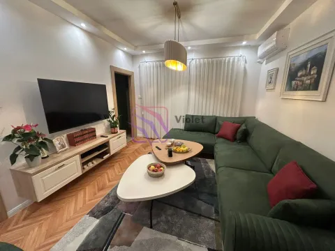 Dnevna soba sa zelenom ugaonom garniturom, TV komodom i parketom. - image 4