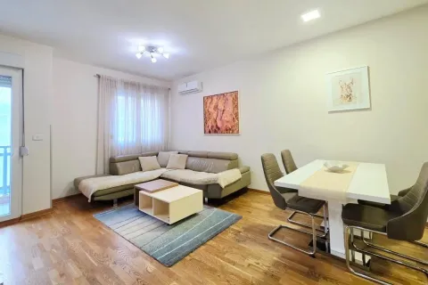 Living room with a sofa and dining table. - image 4