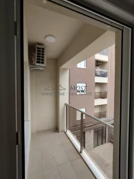 A view of a spacious enclosed balcony with a glass railing. - image 7