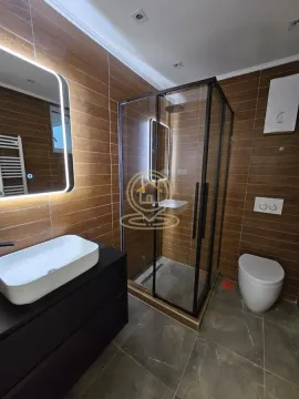 Modernly equipped bathroom with a shower cabin, washbasin, and toilet. - image 14