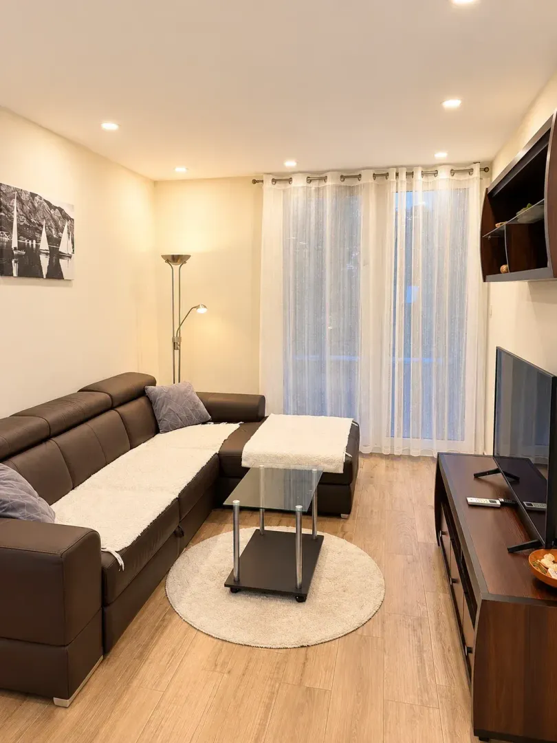 Living room with a sectional sofa, coffee table, and TV.